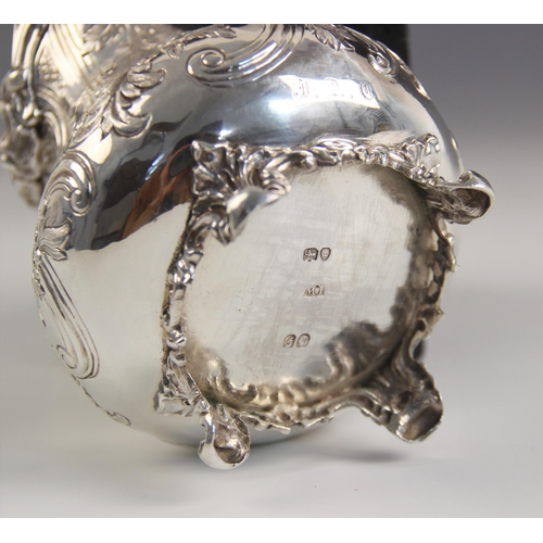 78 - A Victorian silver milk jug, possibly John Wellby, London 1841, the cast foliate rim above an emboss... 