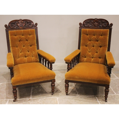 781 - A pair of Victorian carved walnut open armchairs, probably by S J Waring & Sons, Liverpool, the shap... 