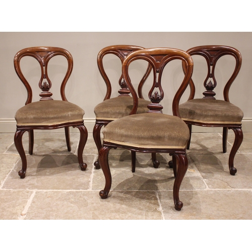 791 - A set of four Victorian mahogany dining chairs, each with a balloon back and pierced vase shaped spl... 