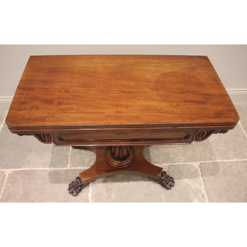 801 - A William IV mahogany games table, the rectangular folding top with rounded corners opening to a cir... 