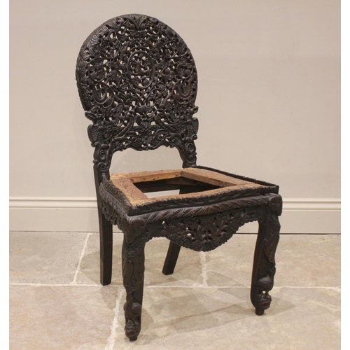 806 - A Ceylonese hardwood chair, late 19th/early 20th century, the arched openwork back rest carved with ... 