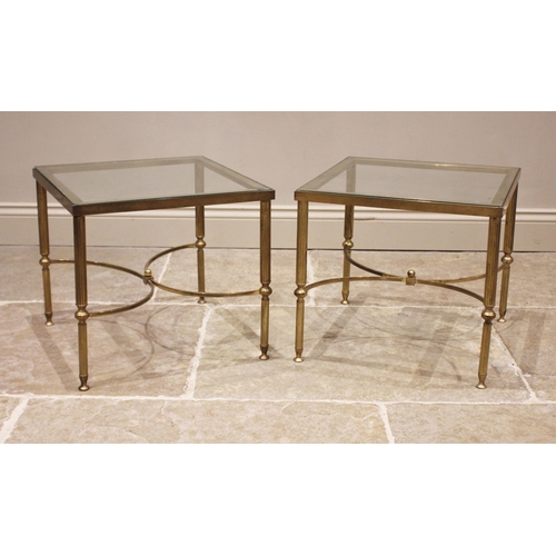 840 - A pair of glass top 'Hollywood Regency' lamp tables, mid 20th century, upon fluted cylindrical brass... 