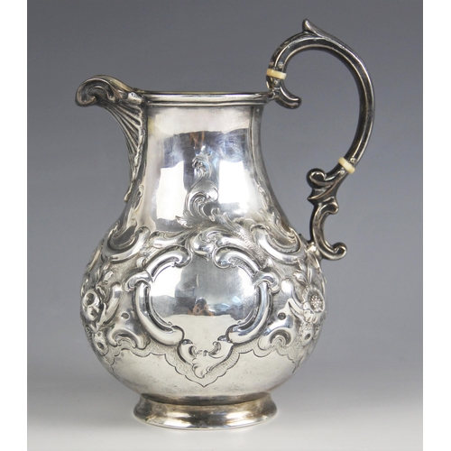 95 - A Victorian silver baluster jug, George Richards Elkington, London 1856, the shell cast spout above ... 