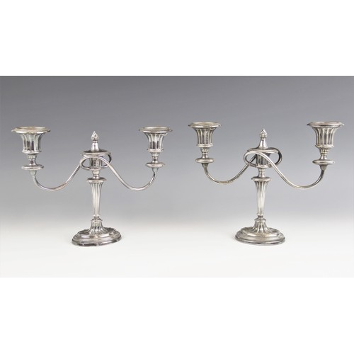 12 - A pair of Edwardian silver candelabras, Ellis & Co, Birmingham 1906, the tapering fluted stems above... 