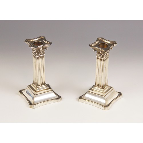 15 - A pair of Victorian silver Corinthian column candlesticks, Martin, Hall & Co, Sheffield 1898, each o... 