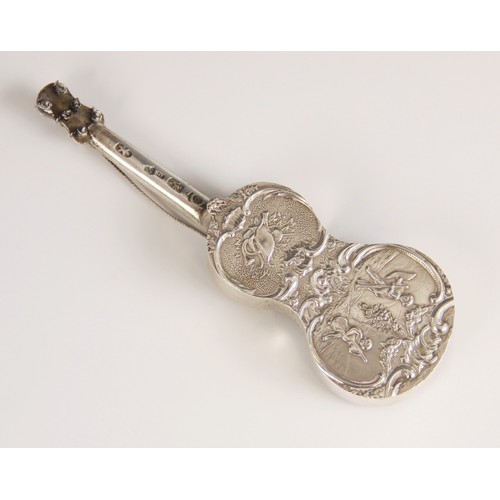 18 - A Dutch silver miniature model of a guitar, of typical form, embossed with cherubs playing instrumen... 