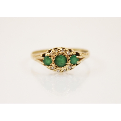 181 - An emerald and diamond 9ct gold ring, the three graduated round cut emeralds within a border of diam... 