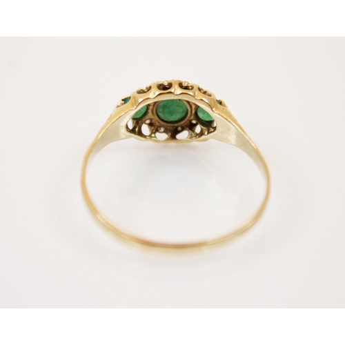 181 - An emerald and diamond 9ct gold ring, the three graduated round cut emeralds within a border of diam... 