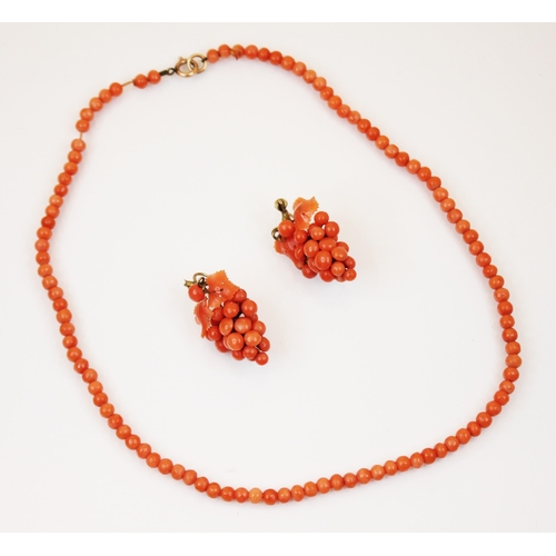 201 - A coral bead necklace, designed as one hundred three uniform circular beads, with yellow metal bolt ... 