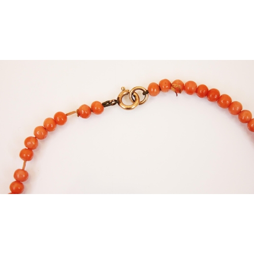 201 - A coral bead necklace, designed as one hundred three uniform circular beads, with yellow metal bolt ... 