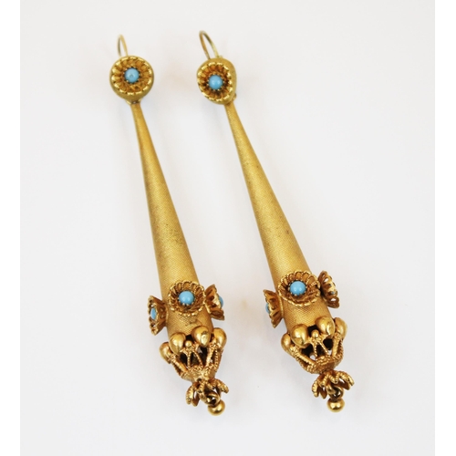 202 - A pair of late 19th century yellow metal earrings, the turquoise coloured cabochon within an openwor... 