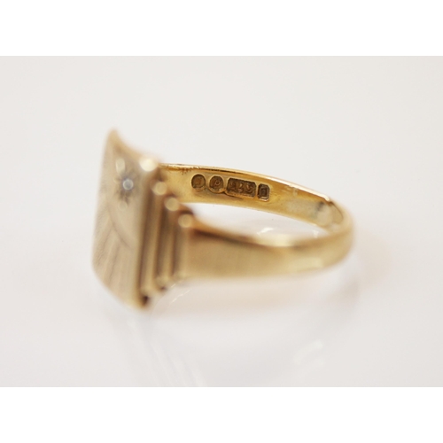 216 - A 9ct yellow gold signet ring, the rectangular shaped head with diamond chip set sun engraved detail... 