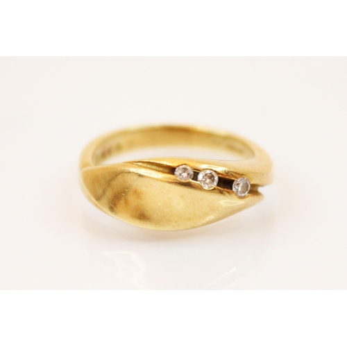 218 - A three stone diamond and 18ct yellow gold ring, the head of the ring designed as moulded leaf shape... 