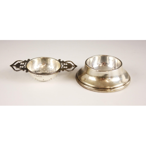 4 - A George VI silver tea strainer and stand, the strainer with twin pierced handles, and plain polishe... 