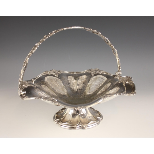 147 - A silver plated swing handled fruit bowl, the cast pierced floral handle above a conforming engraved... 