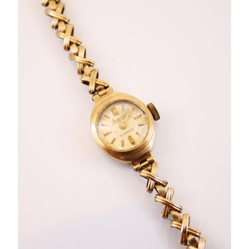 157 - A 9ct gold ladies Accurist wristwatch, the circular cream coloured dial with Arabic numerals and bat... 