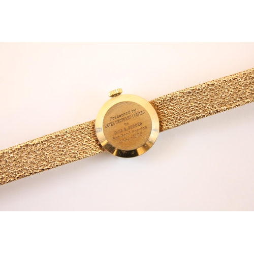 158 - A 9ct gold ladies Garrard wristwatch, the circular cream coloured dial with Arabic numeral and baton... 