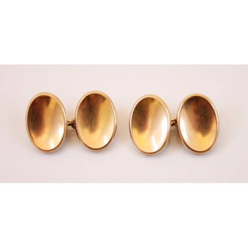 190 - A pair of yellow metal cufflinks, each link of oval concave plain polished form, 17mm long, with tra... 