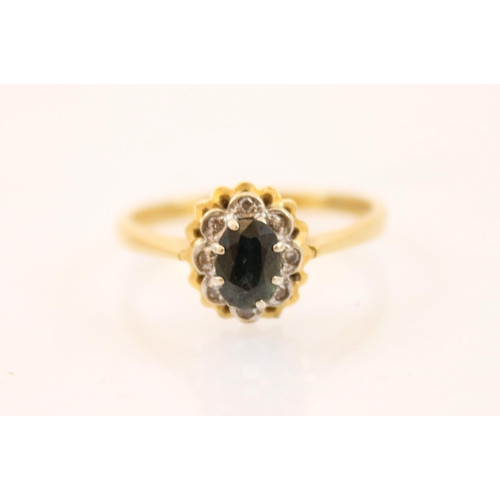 199 - A sapphire and diamond 18ct gold ring, the central oval sapphire claw set within a surround of eight... 