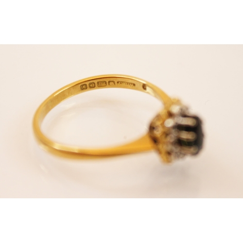 199 - A sapphire and diamond 18ct gold ring, the central oval sapphire claw set within a surround of eight... 