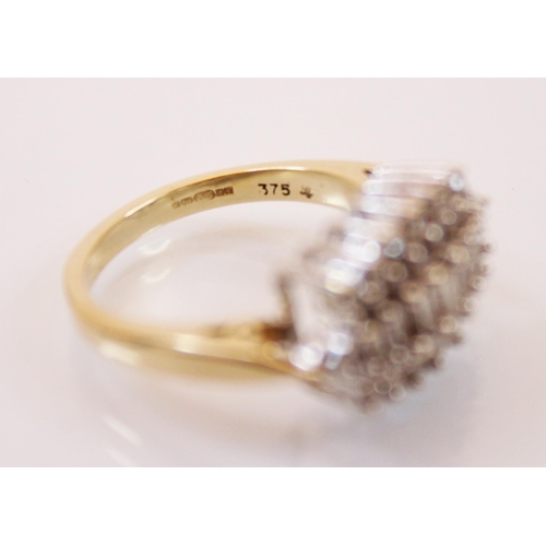 211 - A diamond rectangular shaped cluster ring, with a central line of graduated baguette cut diamonds (e... 