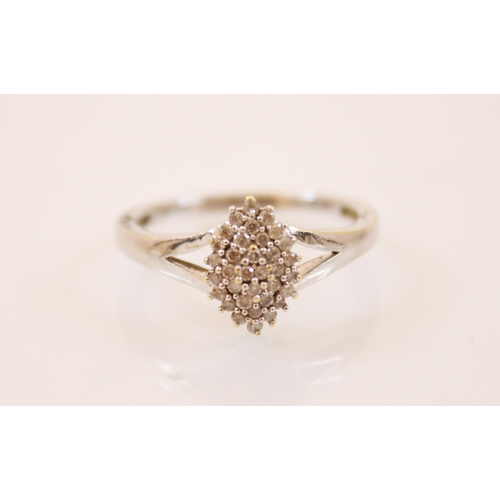 212 - A diamond cluster ring, of marquise design with claw set round cut diamonds set within white metal s... 