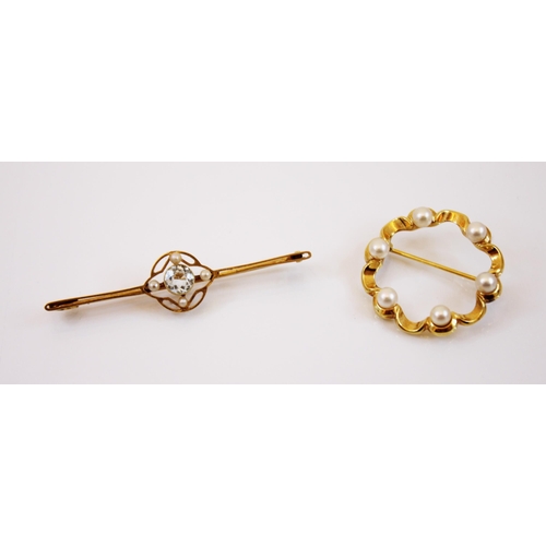 220 - An aquamarine and seed pearl yellow metal bar brooch, the central round cut aquamarine set within an... 