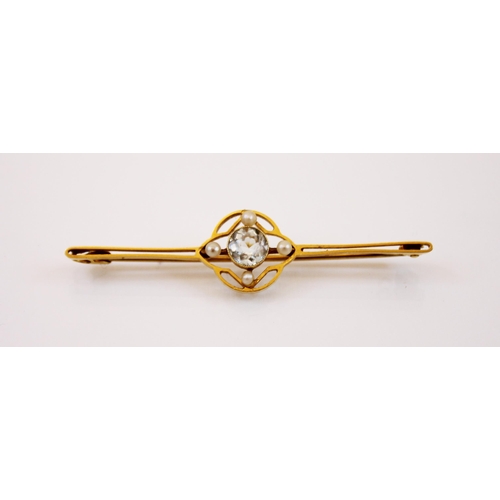 220 - An aquamarine and seed pearl yellow metal bar brooch, the central round cut aquamarine set within an... 