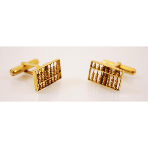 236 - A pair of gold coloured cufflinks, each designed as abacus, stamped 14k, with a similar stud with sa... 