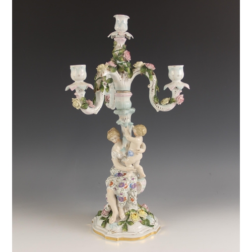 473 - A German porcelain florally encrusted four branch candelabrum by Dornheim, Koch, & Fischer, late 19t... 