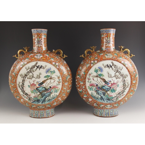 437 - A large pair of Chinese porcelain moon flasks, 19th century (Xianfeng / Tongzhi), each centrally dec... 