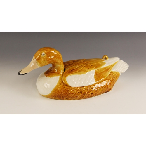 481 - A Portuguese pottery duck egg holder, modelled as a yellow and white duck with removable back, impre... 