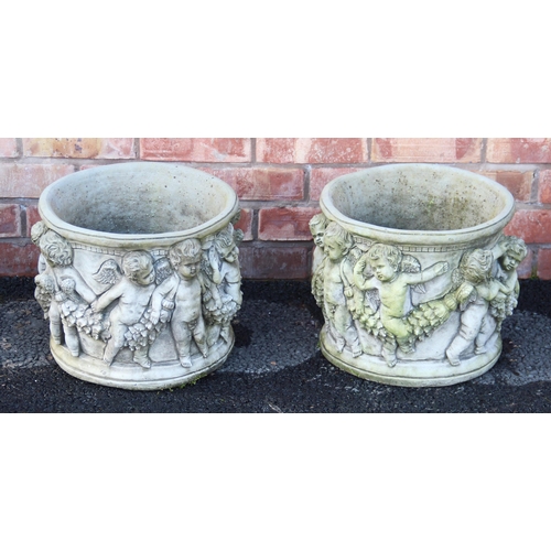 713 - A pair of reconstituted stone circular planters, moulded in relief with cherubs and leafy swags, 31c... 