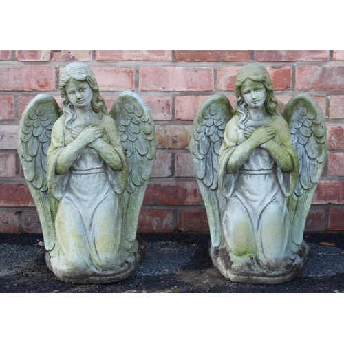 714 - A pair of reconstituted stone garden ornaments, modelled as kneeling angels with arms crossed, 56cm ... 