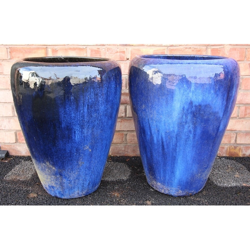 719 - A pair of contemporary blue glazed stoneware planters, of tapering cylindrical form, 64cm high (2)