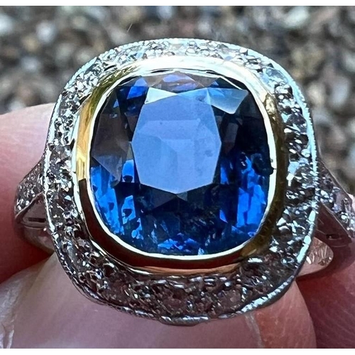 226 - A certified Burmese sapphire and diamond cluster ring, the central cushion cut sapphire (6.05 carats... 