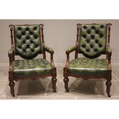 785 - A pair of Victorian oak and olive green leather library chairs, in the manner of Holland & Sons, the... 