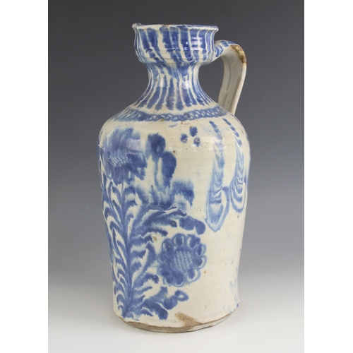 474 - A continental blue and white tin glazed earthenware flagon, 19th century, of typical form with funne... 