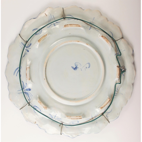 478 - A Cantagalli blue and white faience charger, 19th century, the relief moulded shell and scroll rim e... 