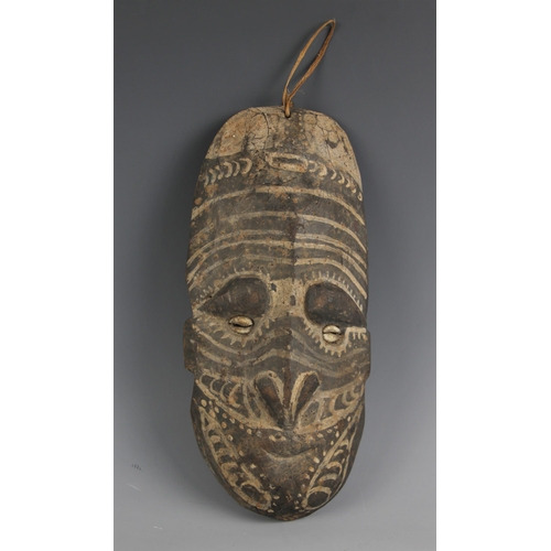 405 - A Papua New Guinea tribal mask, 20th century, the oval long oval shaped face with painted decoration... 