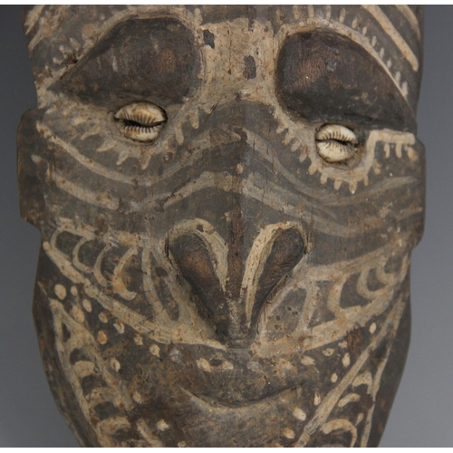 405 - A Papua New Guinea tribal mask, 20th century, the oval long oval shaped face with painted decoration... 