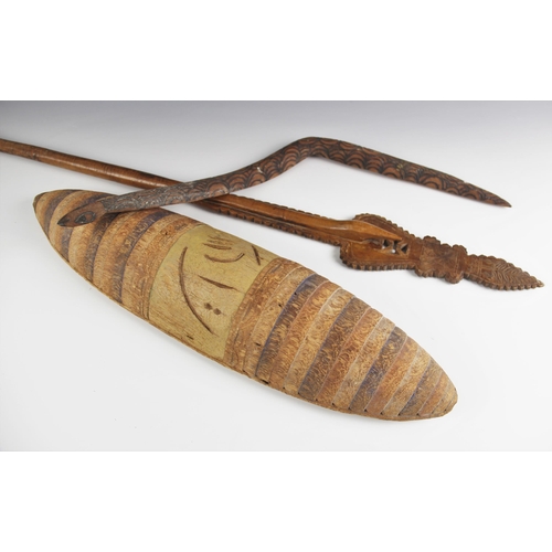 413 - An Australian Aboriginal tribal art wooden shield, 57cm long, a carved Aboriginal snake totem with b... 