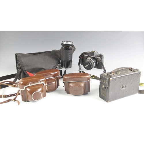 583 - A selection of vintage camera equipment, to include a Nikon F-301 35mm single lens reflex camera wit... 