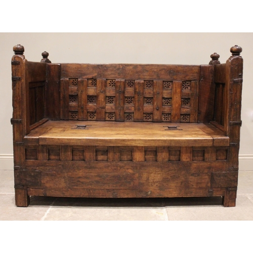 805 - An Indian hardwood box settle, 19th century and later, the panelled back board punctuated with pierc... 