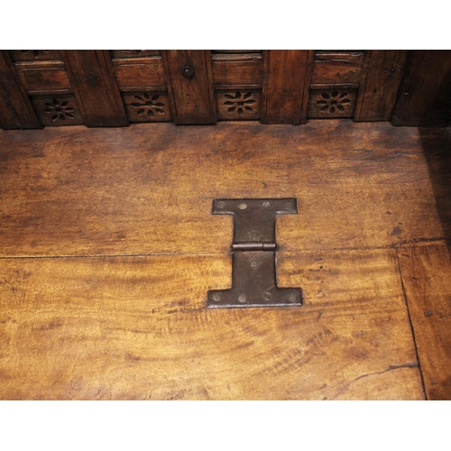 805 - An Indian hardwood box settle, 19th century and later, the panelled back board punctuated with pierc... 