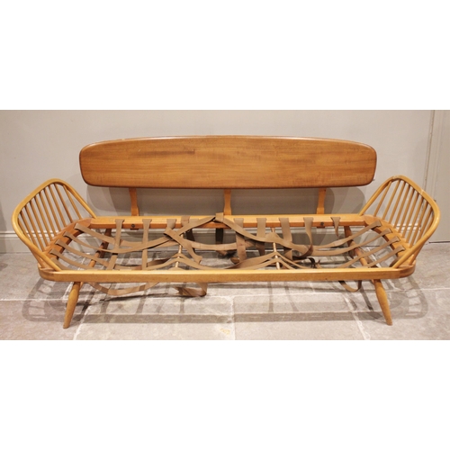 832 - An Ercol honey elm and beech studio couch/day bed, mid 20th century, the detachable back rest extend... 