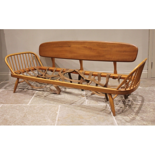 832 - An Ercol honey elm and beech studio couch/day bed, mid 20th century, the detachable back rest extend... 