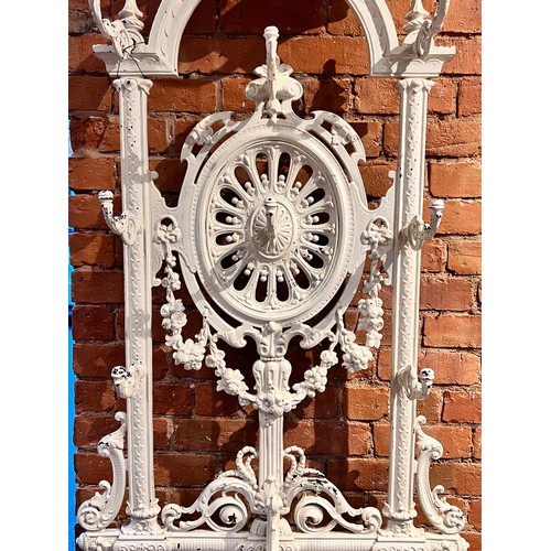 578 - A Victorian Coalbrookdale style cast iron hall stand, of arched form, with eight scrolled hooks, the... 