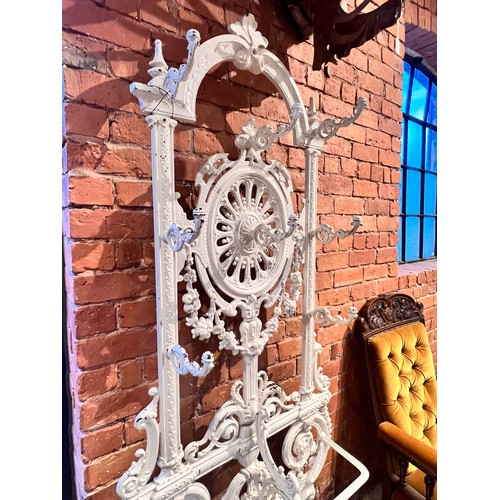 578 - A Victorian Coalbrookdale style cast iron hall stand, of arched form, with eight scrolled hooks, the... 