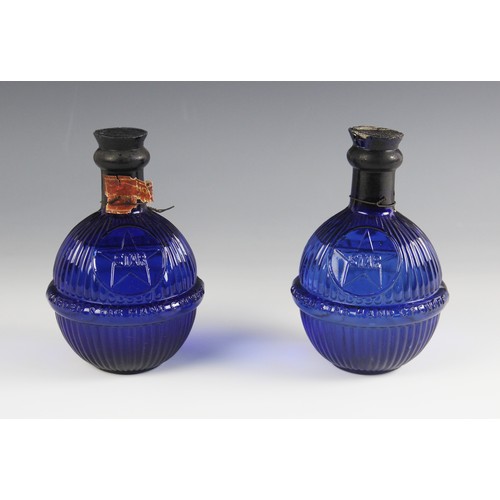 572 - A pair of Hardens 'Star' cobalt blue fire grenades, of typical ribbed bulbous form, moulded with the... 